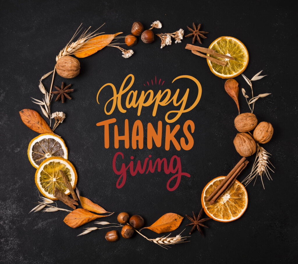 A wreath on a black background with the words happy thanksgiving in the center