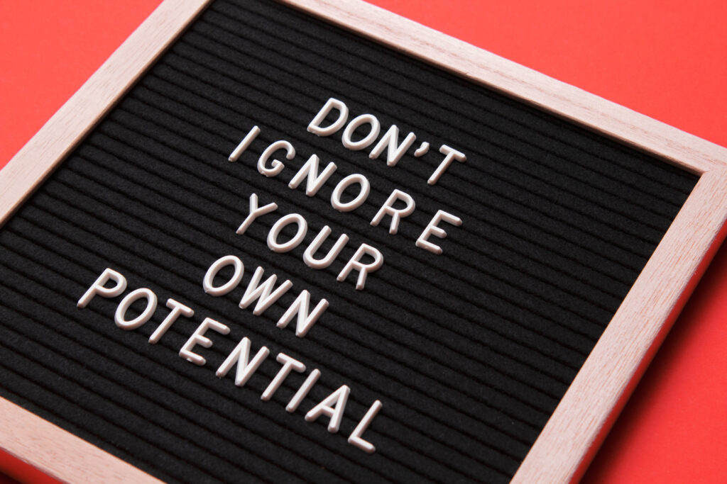 The words "Don't Ignore Your Own Potential" on a black letterboard