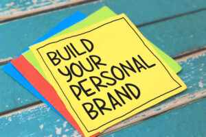 Build your personal brand, text words written on paper against wooden background