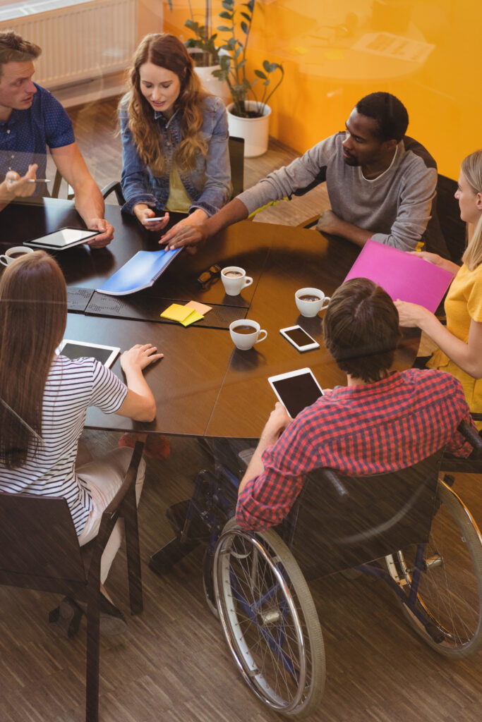 Business executives interacting with each other during meeting in office