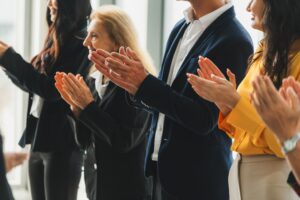 Group of business people clapping hands at successful presentation or conference. 