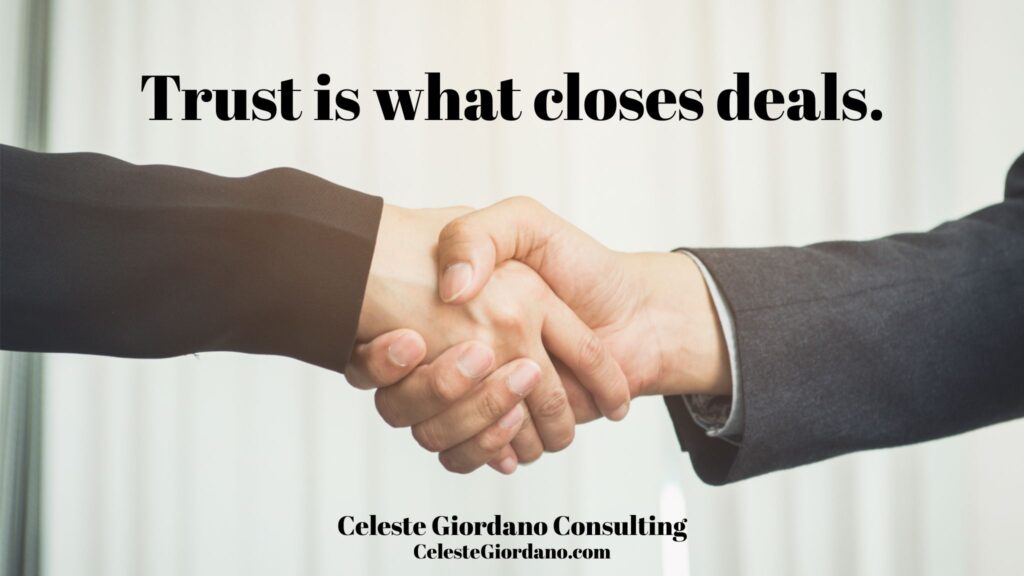 A picture of two hands shaking with the words "Trust is what closes deals."